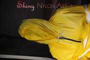 Sandra being tied and gagged on a hairdresser´s chair wearing sexy yellow shiny nylon rainwear being double hooded (Pics)