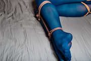 Yellow-blue tied legs in nylon stockings
