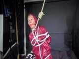 Watch Sandra bound gagged and noosed wearing her shiny nylon Rainwear