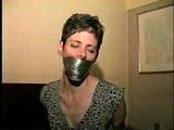 47 Yr OLD UNCOOPERATIVE BRAT LATINA HAIR DRESSER IS WRAP TAPE GAGGED, WIDE EYED GAG TALKING, BOUND UP WITH DUCT TAPE AND BAREFOOT (D59-11)