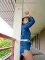 Leonie tied and gagged on a pillar wearing a shiny nylon shorts and a rain jacket (Pics)