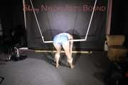 Sonja being tied and gagged overhead and on a bar wearing a sexy white top and a lightblue shiny nylon shorts (Pics)