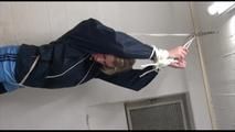 Pia tied and gagged over head in a laundry wearing a supersexy black leggins and a blue shiny nylon adidas shorts as well as a blue rain jacket (Video) 