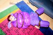 Jill tied and gagged with webbing load restraint assembly on the floor wearing a sexy purple down jacket and a rain pants (Pics)