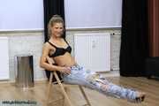 Hot jeans girl cuffed on a chair