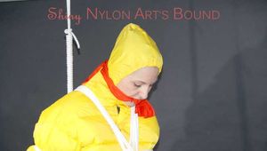 Mara wearing a sexy black rain pants, red rubber boots and a yellow down jacket tied and gagged with ropes and a cloth gag on the ceiling (Pics)