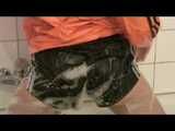 Watching sexy Katharina wearing a sexy black shiny nylon shorts and an orange downjacket enjoying her foambath (video)