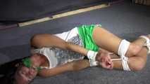 Sexy Sandra being tied and gagged on the floor wearing a sexy green shiny nylon shorts and a white top (Video)