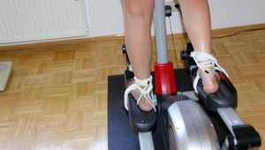Pia tied and gagged on a crosstrainer for doing her workout right wearing a sexy blue shiny nylon shorts and an oldschool rain jacket (Pics)