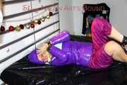 Pia wearing a pink rain pants and a purple down jacket tied with cuffs and gagged on bed (Pics) 