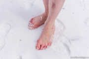 Katrin barefoot in the snow.