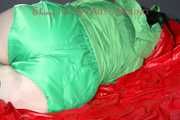 ***HOT HOT HOT*** LUCY tied and gagged on a bed with a bar and a cloth gag wearing sexy green shiny nylon shorts and a green rain jacket (Pics)