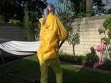 Watch Chloe enjoying the warm Sun in her yellow shiny nylon Rainsuit 