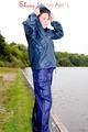Sexy archive girl wearing a blue rain pant and rain jacket walking on a lake in freetime (Pics)