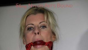 Sexy Lucy tied an gagged with ropes and a cloth gag wearing a super hot red shiny nylon shorts and a yellow rain jacket (Pics)