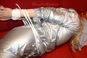 Sophie tied and gagged on the sofa wearing a shiny silver PVC sauna suit (Pics)