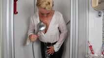 Blonde Frida takes a shower in her white shirt and black glossy pants