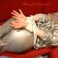 Sophie tied and gagged on the sofa wearing a shiny silver PVC sauna suit (Pics)