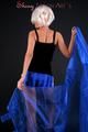 Blonde archive girl posing in a studio with a nylon scarf wearing a sexy blue shiny nylon shorts and a black top (Pics)