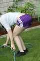 Watch Chloe watering the Garden enjoying her shiny nylon Shorts