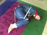 01:00 Min. video with an archive girl tied and gagged in shiny nylon rainwear