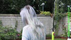 Watch Chloe watering the Garden enjoying her shiny nylon Shorts
