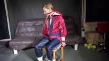Watching sexy SANDRA being tied and gagged with ropes and a clothgag on a chair wearing sexy oldschool shiny nylon rainwear (Video)