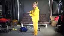 Watching sexy SANDRA vacuum cleaning the studio wearing a sexy yellow rainwear combination (Video)