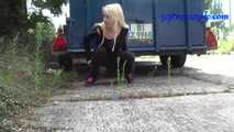 069017 Tiffany Pees Behind A Parked Trailer