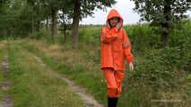 Miss Petra takes a walk in a orange AGU rain suit and rubber boots