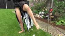 Watching Aiyana wearing a sexy black shiny nylon rainpant and a black shiny nylon down jacket trying the garden shower  (Video)