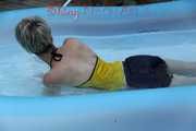 Sexy Sonja wearing a darkblue shiny nylon shorts and a yellow top enjoying the water in the swimming pool (Pics)