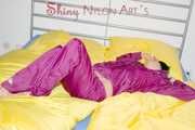 ENNI wearing a sexy purple shiny nylon rain suit lying in bed with yellow shiny nylon cloths lolling and posing (Pics)