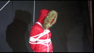 ***SEXY MARA*** wearing a supersexy black shiny nylon pants and a red shiny nylon down jacket with a coat being bound overhead with ropes and a ball gag (Video)