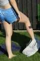 Watch Chloe taking a Sunbath wearing her shiny nylon Shorts under her jeans Shorts 