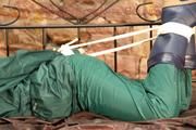 Pia tied, gagged and hooded in a princess bed wearing sexy shiny green rainwear (Pics)