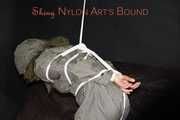 Sexy Sandra being tied and gagged overhead with ropes and a clothgag hodded wearing a sexy rainwear combination (Pics)
