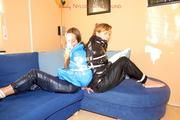 two of our archive girls bound and gagged in shiny nylon down jackets