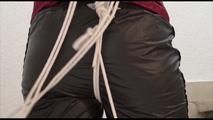 Jill ties, gagges and hoodes herself on a strairway wearing sexy shiny nylon rainwear (Video)