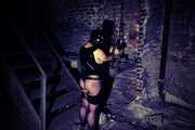 Slave in latex and chains in the horror tower