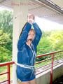 Leonie tied and gagged on a pillar wearing a shiny nylon shorts and a rain jacket (Pics)