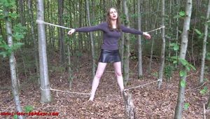 Mitzi tied up between 2 trees