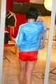 SEXY ENNI wearing a hot red shiny nylon shorts and a lightblue shiny nylon rain jacket during ironing the shirt of her boyfriend (Pics)