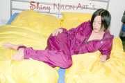 ENNI wearing a sexy purple shiny nylon rain suit lying in bed with yellow shiny nylon cloths lolling and posing (Pics)