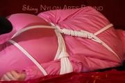 Lucy tied and gagged on a sofa wearing a pink shiny nylon skibib (Pics)