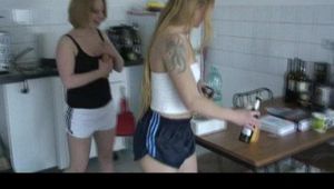 Katharina and a blonde archive girl at home preparing coffee and and lolling on the balcony wearing shiny nylon shorts and a rain jacket (Video)
