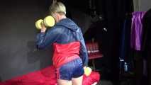 Watching sexy Sonja wearing a blue/red shiny nylon shorts and blue/red rain jacket during her workout with dumbbells (Video)