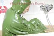 MARA ties and gagges herself in a bath tub cuffs and a cloth gag wearing a super sexy super shiny green rubber rainsuit (Pics)