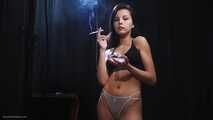 Sexy brunette is smoking two all white 120mm cigarettes wearing an underwear