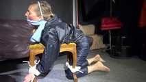 Watching sexy Sandra wearing a sexy blue shiny nylon pants and a rain jacket being tied and gagged with ropes and a clothgag on a stool (Video)